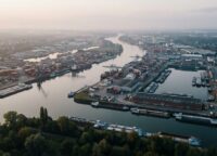 Aerial view of Duisburg inland port with cargo ships and containers at dawn